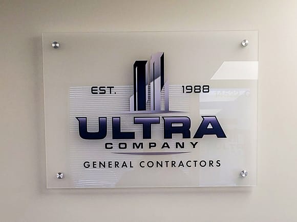 3/8" thick acrylic backed sign. The acrylic has NRM PS2 mounted to the back and a full color printed logo on the front.
